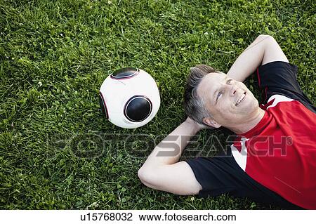 Soccer Player Relaxing On Grass View Large Photo Image Stock Image - Soccer Player Relaxing On Grass. Fotosearch