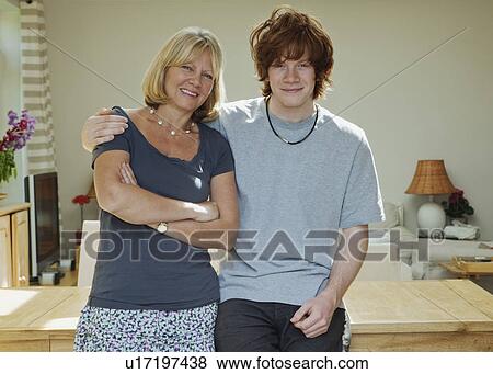 Son standing with arms around mother View Large Photo Image Stock Photo - Son standing with arms around mother. Fotosearch