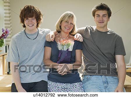 Sons standing with arms around mother View Large Photo Image Stock Image - Sons standing with arms around mother. Fotosearch