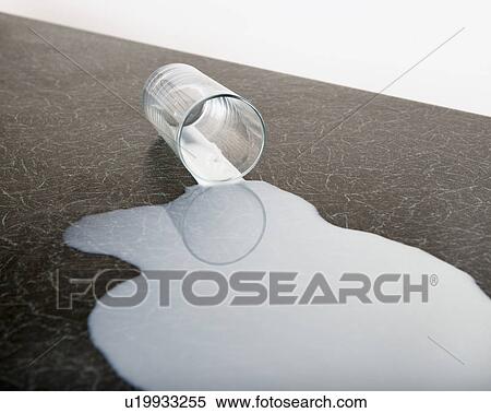 Stock Photography - spilt glass of milk. Fotosearch