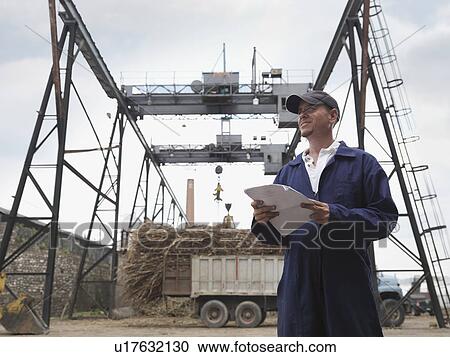 Stock Image - Sugar Cane Worker At Processing Plant. Fotosearch