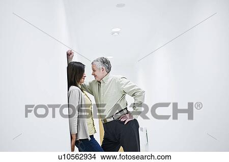 Picture - suggestive couple in corridor. Fotosearch