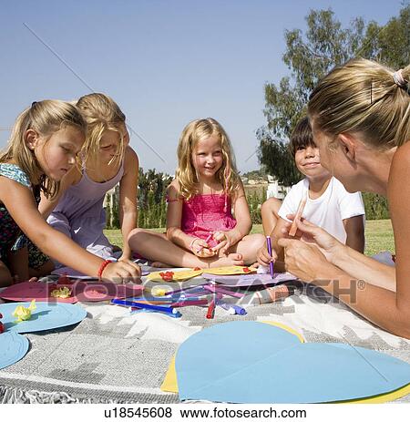 Teacher teaching students art & crafts View Large Photo Image Stock Photo - Teacher teaching students art & crafts. Fotosearch