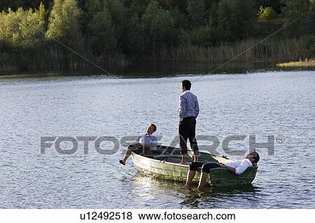 three businessmen relaxing in rowboat View Large Photo Image Stock Photo - three businessmen relaxing in rowboat. Fotosearch
