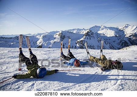 Three children lying in the snow. View Large Photo Image Stock Image - Three children lying in the snow.. Fotosearch