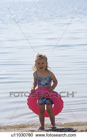 Stock Image - Toddler on the beach. Fotosearch