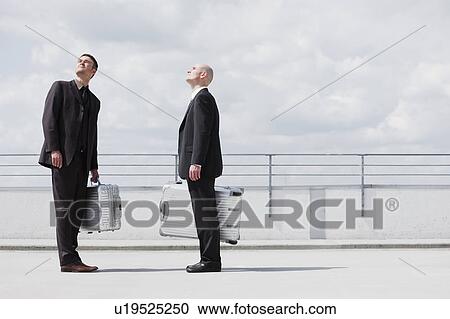 Stock Image - two business men with suitcases. Fotosearch