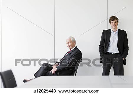 two businessmen in meeting room View Large Photo Image Stock Image - two businessmen in meeting room. Fotosearch