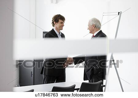 two businessmen in meeting room View Large Photo Image Stock Image - two businessmen in meeting room. Fotosearch
