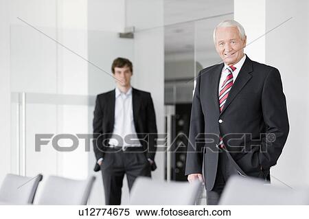 Stock Photography - two businessmen in meeting room. Fotosearch