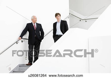 two businessmen on staircase View Large Photo Image Picture - two businessmen on staircase. Fotosearch