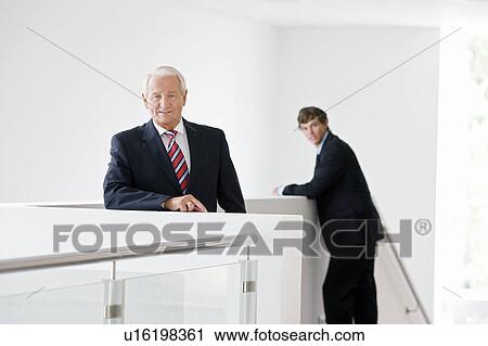 Stock Image - two businessmen on staircase. Fotosearch