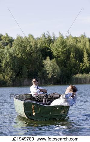 two businessmen relaxing in rowboat View Large Photo Image Stock Image - two businessmen relaxing in rowboat. Fotosearch