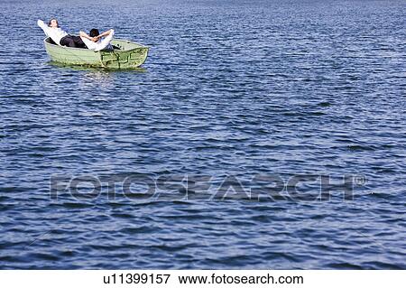 Stock Photo - two businessmen relaxing in rowboat. Fotosearch