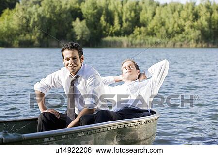 two businessmen relaxing in rowboat View Large Photo Image Stock Photograph - two businessmen relaxing in rowboat. Fotosearch