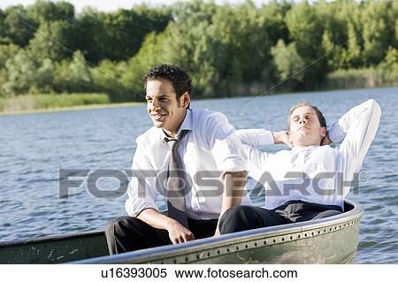 Stock Photography - two businessmen relaxing in rowboat. Fotosearch