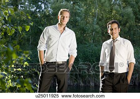 Stock Photography - two businessmen standing in nature. Fotosearch