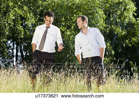 two businessmen talking in field View Large Photo Image Stock Image - two businessmen talking in field. Fotosearch