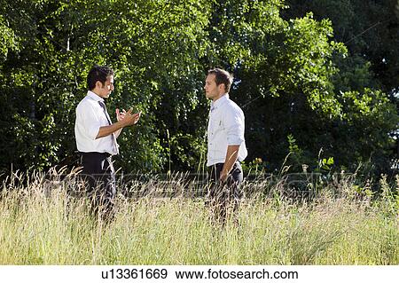 two businessmen talking in nature View Large Photo Image Stock Photo - two businessmen talking in nature. Fotosearch