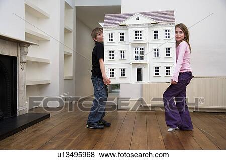 Stock Photo - Two children carrying a dollhouse. Fotosearch