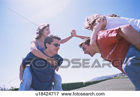 Two couples having fun in the park View Large Photo Image Stock Photo - Two couples having fun in the park. Fotosearch