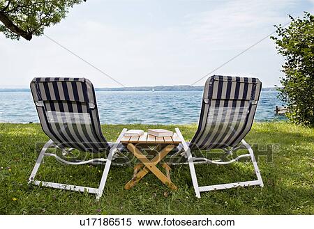 two deck chairs and books at lake View Large Photo Image Stock Photography - two deck chairs and books at lake. Fotosearch