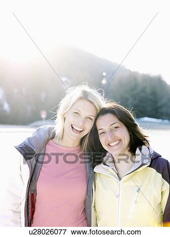 two girls in snow on hillside View Large Photo Image Stock Photo - two girls in snow on hillside. Fotosearch