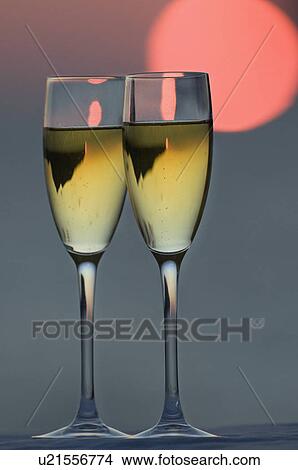 Picture - Two glasses of champagne at sunset. Fotosearch