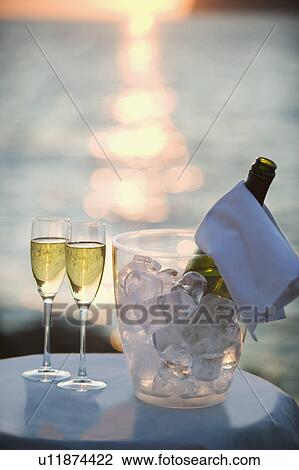 Stock Image - Two glasses of champagne at sunset. Fotosearch