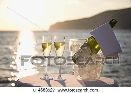 Stock Photo - Two glasses of champagne at sunset. Fotosearch