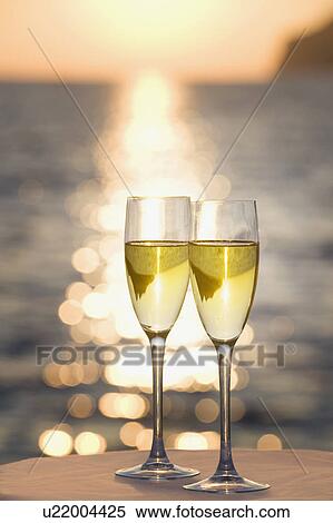 Stock Photography - Two glasses of champagne at sunset. Fotosearch