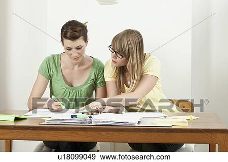 Stock Photo - Two students sitting at table. Fotosearch