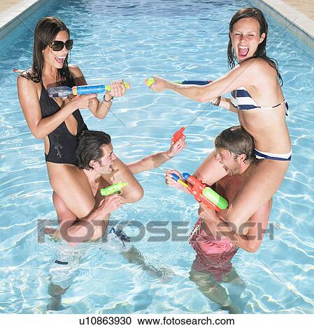 Stock Image - water fight between couples. Fotosearch