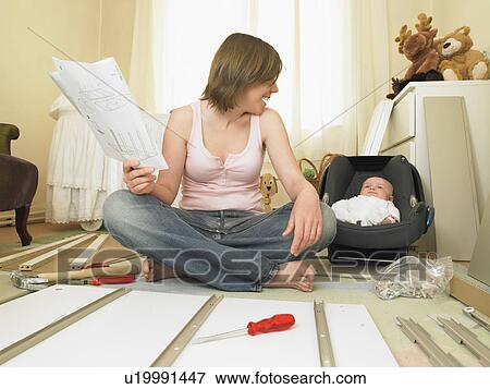 Woman and baby building furniture View Large Photo Image Stock Photo - Woman and baby building furniture. Fotosearch
