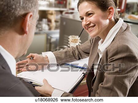 Stock Photograph - woman and man having discussion at bar. Fotosearch