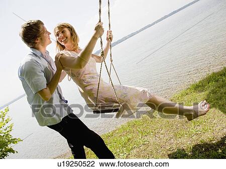woman and man kissing on swing View Large Photo Image Stock Image - woman and man kissing on swing. Fotosearch