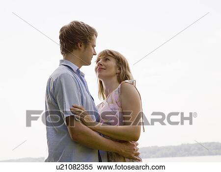 Stock Photography - woman and man kissing. Fotosearch
