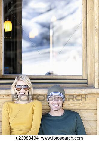 Picture - woman and man outside bar. Fotosearch