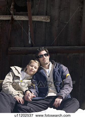Stock Photo - woman and man relaxing by hut. Fotosearch