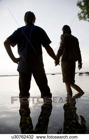 woman and man standing in lake View Large Photo Image Stock Image - woman and man standing in lake. Fotosearch