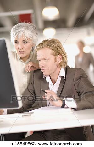Stock Image - woman and man working in an office. Fotosearch