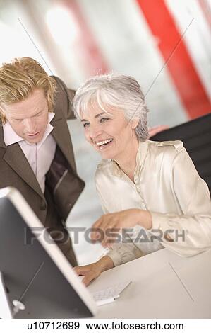 woman and man working in an office View Large Photo Image Stock Photo - woman and man working in an office. Fotosearch