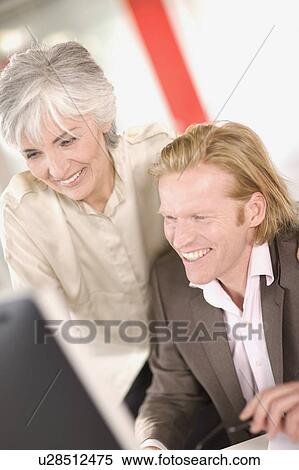 woman and man working in an office View Large Photo Image Stock Photography - woman and man working in an office. Fotosearch