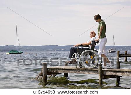 woman and senior man in wheelchair View Large Photo Image Stock Image - woman and senior man in wheelchair. Fotosearch