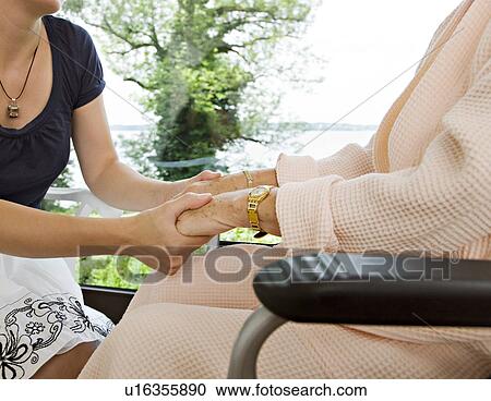 woman and senior woman holding hands View Large Photo Image Stock Image - woman and senior woman holding hands. Fotosearch