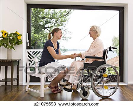 woman and senior woman holding hands View Large Photo Image Stock Image - woman and senior woman holding hands. Fotosearch