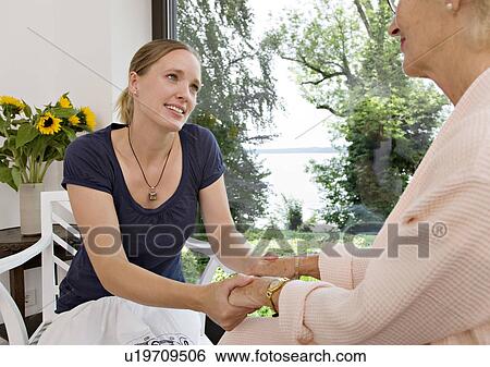 woman and senior woman holding hands View Large Photo Image Stock Photograph - woman and senior woman holding hands. Fotosearch
