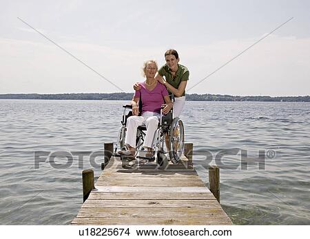 woman and senior woman in wheelchair View Large Photo Image Picture - woman and senior woman in wheelchair. Fotosearch
