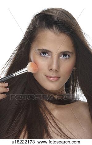 Woman applying blusher to her cheeks View Large Photo Image Stock Image - Woman applying blusher to her cheeks. Fotosearch