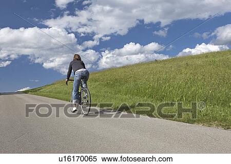 Woman bicycling in the countryside View Large Photo Image Stock Photography - Woman bicycling in the countryside. Fotosearch